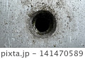 Grungy Industrial Metal Surface with Dark Circular Hole 141470589
