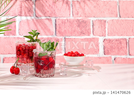 Mojito with sprite, mint and fresh berries,Detox water with raspberries, cherries, and currants, over ice. A refreshing summer homemade lemonade cocktail. Fruit juice and ingredients Mojito with sprite, mint and fresh berries,Detox water with raspberries, cherries, and currants, over ice. A refreshing summer homemade lemonade cocktail. Fruit juice and ingredients 141470626
