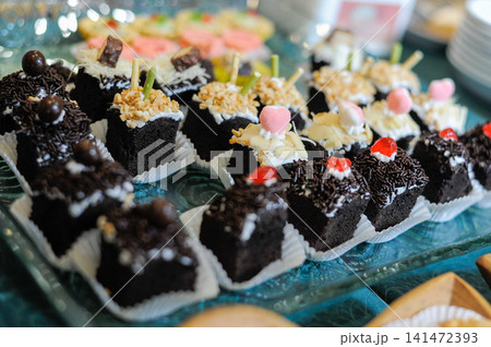 Assorted Chocolate Cake Dessert Buffet with Sweet Toppings on Glass Tray, Bakery Pastries for Catering, Hotel Breakfast, Party Celebration, Close Up Food Photography Assorted Chocolate Cake Dessert Buffet with Sweet Toppings on Glass Tray, Bakery Pastries for Catering, Hotel Breakfast, Party Celebration, Close Up Food Photography 141472393