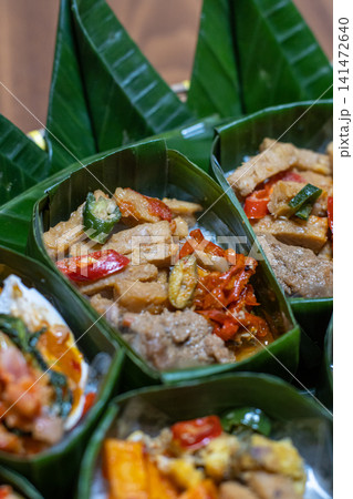 Traditional Indonesian Rice Meal in Banana Leaf Takir with Spicy Tofu, Tempeh, Egg and Sambal, Authentic Nusantara Cuisine, Eco Friendly Food Packaging and Homemade Catering 141472640