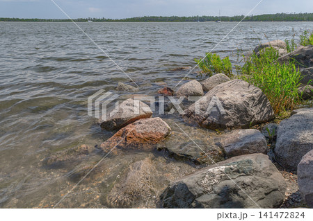 Rocky Lakeshore with Calm Water View 141472824