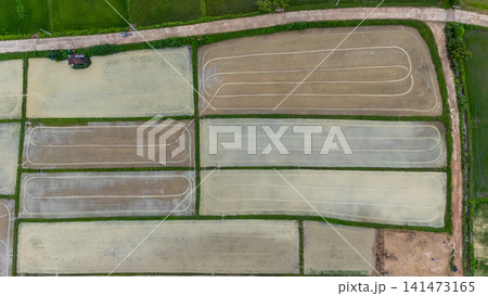Aerial view of rice field after tractor pull a plow through rice field before planting. Conceptual shot of land after preparing for farming. 141473165