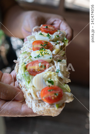 Healthy Open Sandwich with Boiled Egg, Cherry Tomatoes, Lettuce and Creamy Chicken Salad on Artisan Bread, Fresh Homemade Cafe Breakfast or Brunch Close Up Healthy Open Sandwich with Boiled Egg, Cherry Tomatoes, Lettuce and Creamy Chicken Salad on Artisan Bread, Fresh Homemade Cafe Breakfast or Brunch Close Up 141474056