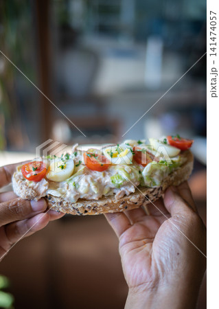 Healthy Open Sandwich with Boiled Egg, Cherry Tomatoes, Lettuce and Creamy Chicken Salad on Artisan Bread, Fresh Homemade Cafe Breakfast or Brunch Close Up 141474057