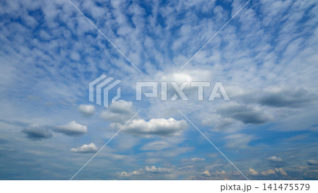 cirrocumulus clouds covering the entire surface of the blue sky cirrocumulus clouds covering the entire surface of the blue sky 141475579