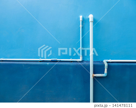 Minimalist White Water Pipes on Two Tone Blue Wall Minimalist White Water Pipes on Two Tone Blue Wall 141478111