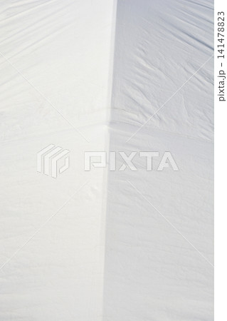 White creased plastic tarp material texture background with seams White creased plastic tarp material texture background with seams 141478823