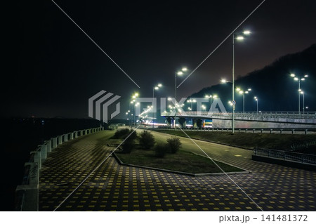 Night promenade and freeway with beautiful blue lanterns. Kyiv embankment at night Night promenade and freeway with beautiful blue lanterns. Kyiv embankment at night 141481372