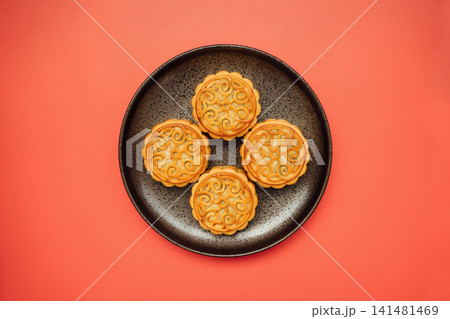 Four Mooncakes on a Dark Plate for Mid-Autumn Festival Four Mooncakes on a Dark Plate for Mid-Autumn Festival 141481469