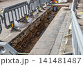 Trench for pipe installation on city street 141481487