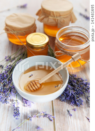 Honey jars with lavender on rustic wooden background 141481695