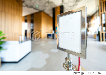 Blank hotel lobby signboard mockup on a queue stand provides clean copy space for branding, directions, announcements, and hospitality messaging. Blank hotel lobby signboard mockup on a queue stand provides clean copy space for branding, directions, announcements, and hospitality messaging. 141481829