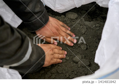 Construction Worker Inspecting Concrete Mix Construction Worker Inspecting Concrete Mix 141481842
