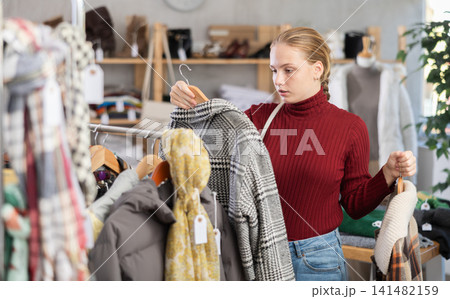 girl, female, teenage, teen, young, 15-16, underage, European, Russian, customer, purchaser, shopper, selective, attentive, hesitant, thoughtful, choosing, buying, holding, looking, selecting, outwear girl, female, teenage, teen, young, 15-16, underage, European, Russian, customer, purchaser, shopper, selective, attentive, hesitant, thoughtful, choosing, buying, holding, looking, selecting, outwear 141482159