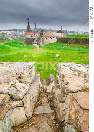 Corridor in the new part of the Old Kamianets-Podilskyi Castle walls with a view to ancient stone walls. Corridor in the new part of the Old Kamianets-Podilskyi Castle walls with a view to ancient stone walls. 141482229