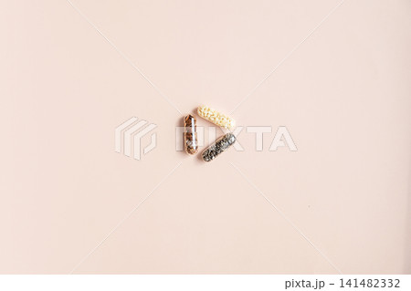 Superfood seeds inside clear capsules on beige background. Superfood seeds inside clear capsules on beige background. 141482332