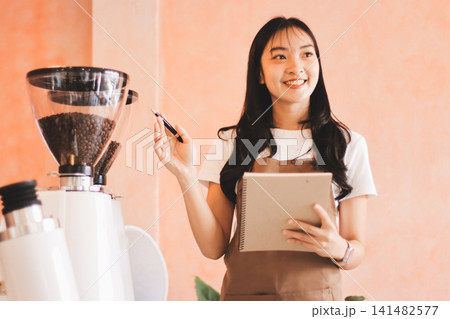 Young woman at barista school learning how to make espresso coffee. Young woman at barista school learning how to make espresso coffee. 141482577
