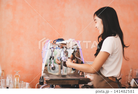 Young woman at barista school learning how to make espresso coffee. Young woman at barista school learning how to make espresso coffee. 141482581