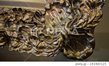 Ornate bronze floral relief detail Ornate bronze floral relief detail 141483125