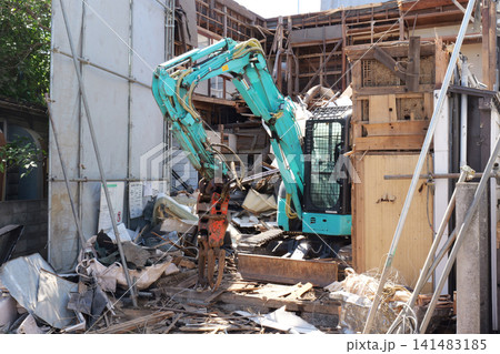 Bulldozer Demolishing Old Building at Construction Site in Japan Bulldozer Demolishing Old Building at Construction Site in Japan 141483185