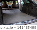 Car trunk cargo space with folded rear seats 141485499