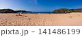Sunny Panoramic Sandy Beach With Cliffs, Sea and People Enjoying Summer Holiday 141486199