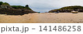 Beached Fishing Boats On Sandy Cove At Low Tide Between Rocky Cliffs Under Overcast Sky 141486258