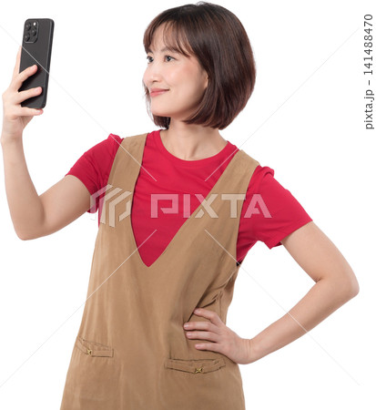 Happy happy asian woman taking selfie picture with smartphone against transparency background showing happy expression during fun online social media mobile phone. PNG file format 141488470