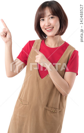 Happy asian woman pointing finger up presenting blank copy space with joyful smile isolated against clean white studio background for creative advertising project. PNG file format Happy asian woman pointing finger up presenting blank copy space with joyful smile isolated against clean white studio background for creative advertising project. PNG file format 141488527