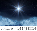 Glowing Star or Christmas Star over the Clouds Shines Brightly in the Starry Night Sky. 141488816