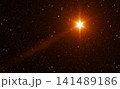 Bright Golden Christmas Star with Rays in the Starry Sky 141489186