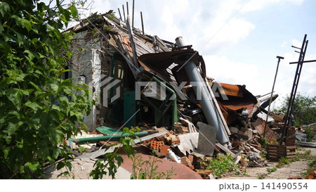 View to destroyed residential buildings at Kharkivska oblast. Ruined houses after bomb attacks on ukrainian territory from russia army. Consequences of russian invasion of Ukraine. Slow motion View to destroyed residential buildings at Kharkivska oblast. Ruined houses after bomb attacks on ukrainian territory from russia army. Consequences of russian invasion of Ukraine. Slow motion 141490554