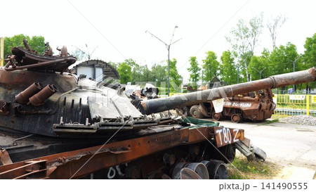 Rusty and burned-out armored vehicles on ukrainian territory. Exhibition of destroyed military equipment of the russian army. War between Ukraine and russia. Close up Slow motion Rusty and burned-out armored vehicles on ukrainian territory. Exhibition of destroyed military equipment of the russian army. War between Ukraine and russia. Close up Slow motion 141490555