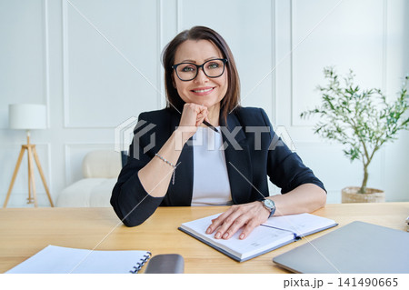Webcam view woman entrepreneur, teacher, blogger working remotely in home office Webcam view woman entrepreneur, teacher, blogger working remotely in home office 141490665