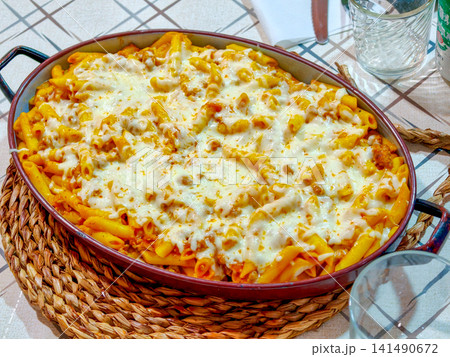 Baked penne pasta in tomato sauce with melted cheese Baked penne pasta in tomato sauce with melted cheese 141490672