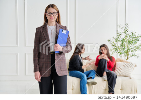 Portrait of professional psychologist therapist woman with clipboard in office 141490697