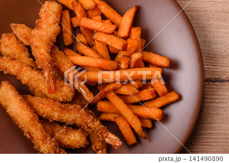 Seasoned sweet potato fries with sauce, fast food. Sweet potato fries Seasoned sweet potato fries with sauce, fast food. Sweet potato fries 141490890