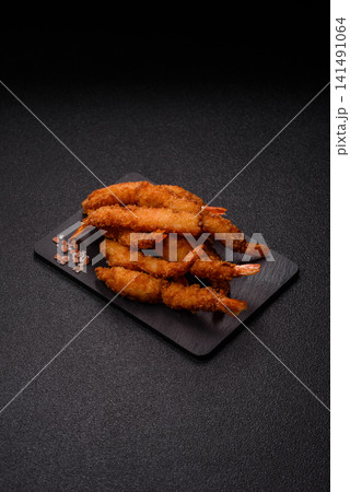 Shrimp or prawn tempura breaded with salt, spices and tartar sauce, Asian cuisine. Tempura shrimp 141491064