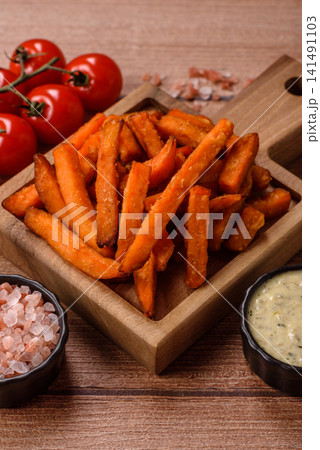 Seasoned sweet potato fries with sauce, fast food. Sweet potato fries Seasoned sweet potato fries with sauce, fast food. Sweet potato fries 141491103