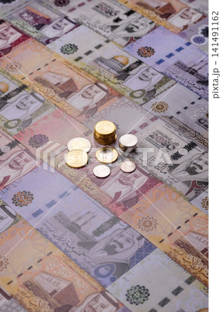 Saudi Arabia paper money, riyal banknotes and coins as currency for exchange. Saudi Arabia money Saudi Arabia paper money, riyal banknotes and coins as currency for exchange. Saudi Arabia money 141491162