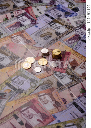 Saudi Arabia paper money, riyal banknotes and coins as currency for exchange. Saudi Arabia money Saudi Arabia paper money, riyal banknotes and coins as currency for exchange. Saudi Arabia money 141491192