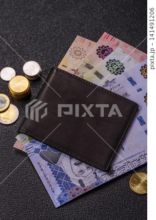 Saudi Arabia paper money, riyal banknotes and coins as currency for exchange. Saudi Arabia money Saudi Arabia paper money, riyal banknotes and coins as currency for exchange. Saudi Arabia money 141491206