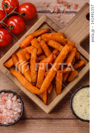 Seasoned sweet potato fries with sauce, fast food. Sweet potato fries Seasoned sweet potato fries with sauce, fast food. Sweet potato fries 141491357