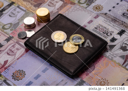Saudi Arabia paper money, riyal banknotes and coins as currency for exchange. Saudi Arabia money Saudi Arabia paper money, riyal banknotes and coins as currency for exchange. Saudi Arabia money 141491368
