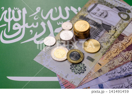 Saudi Arabia paper money, riyal banknotes and coins as currency for exchange. Saudi Arabia money Saudi Arabia paper money, riyal banknotes and coins as currency for exchange. Saudi Arabia money 141491459