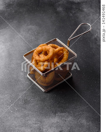 Deep fried breaded onion or squid rings, crispy fast food snacks. Fried onion or squid rings Deep fried breaded onion or squid rings, crispy fast food snacks. Fried onion or squid rings 141491468