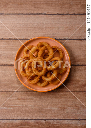 Deep fried breaded onion or squid rings, crispy fast food snacks. Fried onion or squid rings Deep fried breaded onion or squid rings, crispy fast food snacks. Fried onion or squid rings 141491487