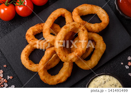 Deep fried breaded onion or squid rings, crispy fast food snacks. Fried onion or squid rings Deep fried breaded onion or squid rings, crispy fast food snacks. Fried onion or squid rings 141491499