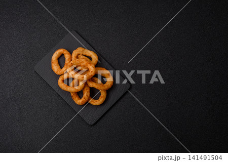 Deep fried breaded onion or squid rings, crispy fast food snacks. Fried onion or squid rings Deep fried breaded onion or squid rings, crispy fast food snacks. Fried onion or squid rings 141491504