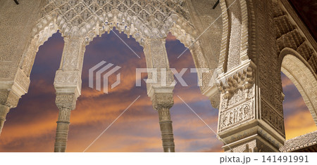 Arches in Islamic (Moorish) style (against the sunset) in Alhambra, Granada, Spain 141491991